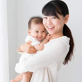 portrait of asian mother and baby in living room